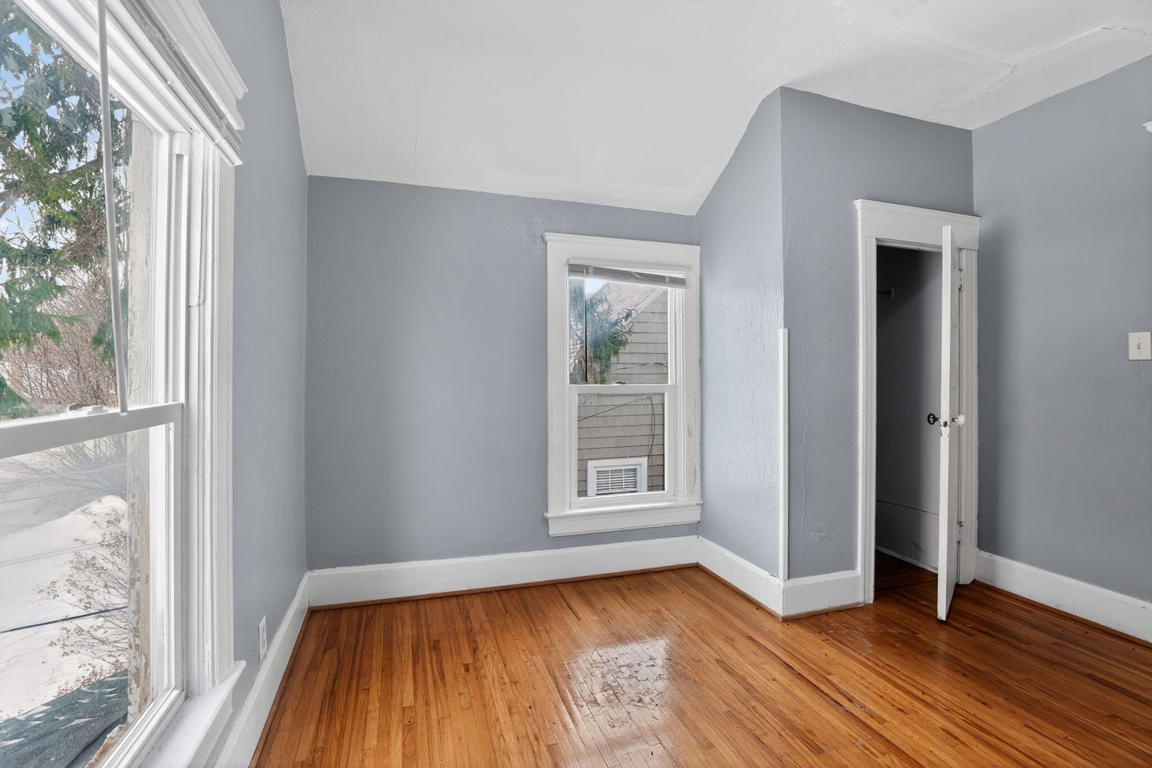 1250 West American Street Freeport, IL 61032 - Photo 15 of 23 an empty room with wooden floor and windows