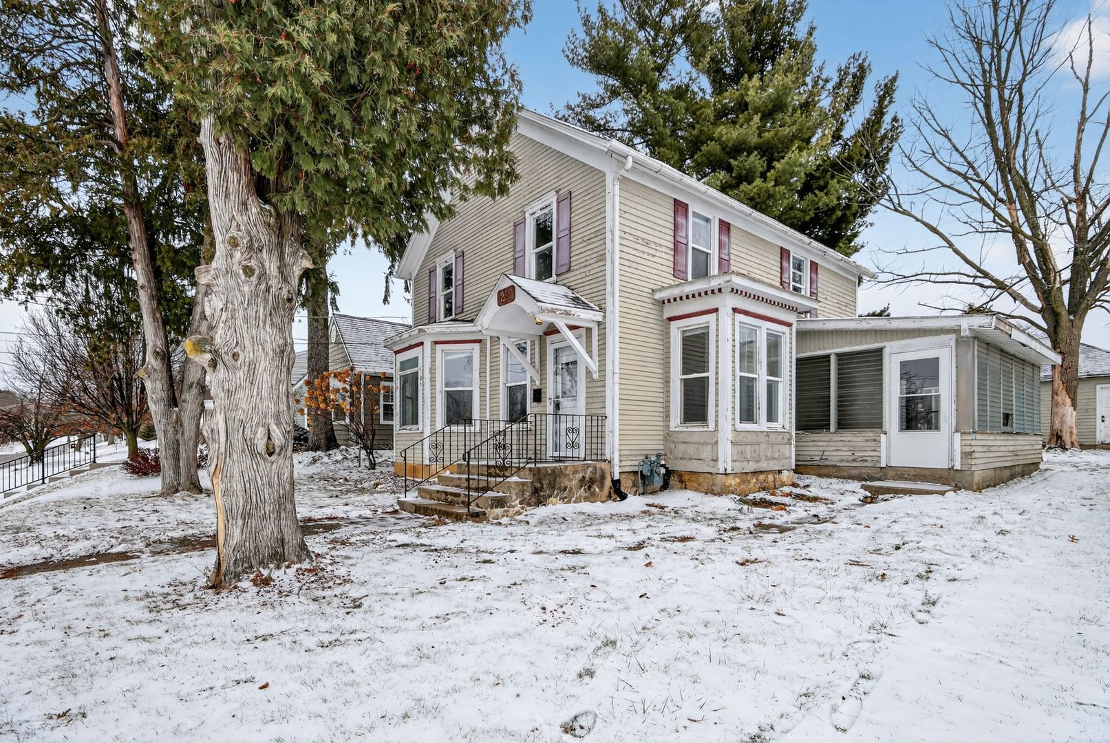 1250 West American Street Freeport, IL 61032 - Photo 2 of 23 a view of a white house with snow on the road