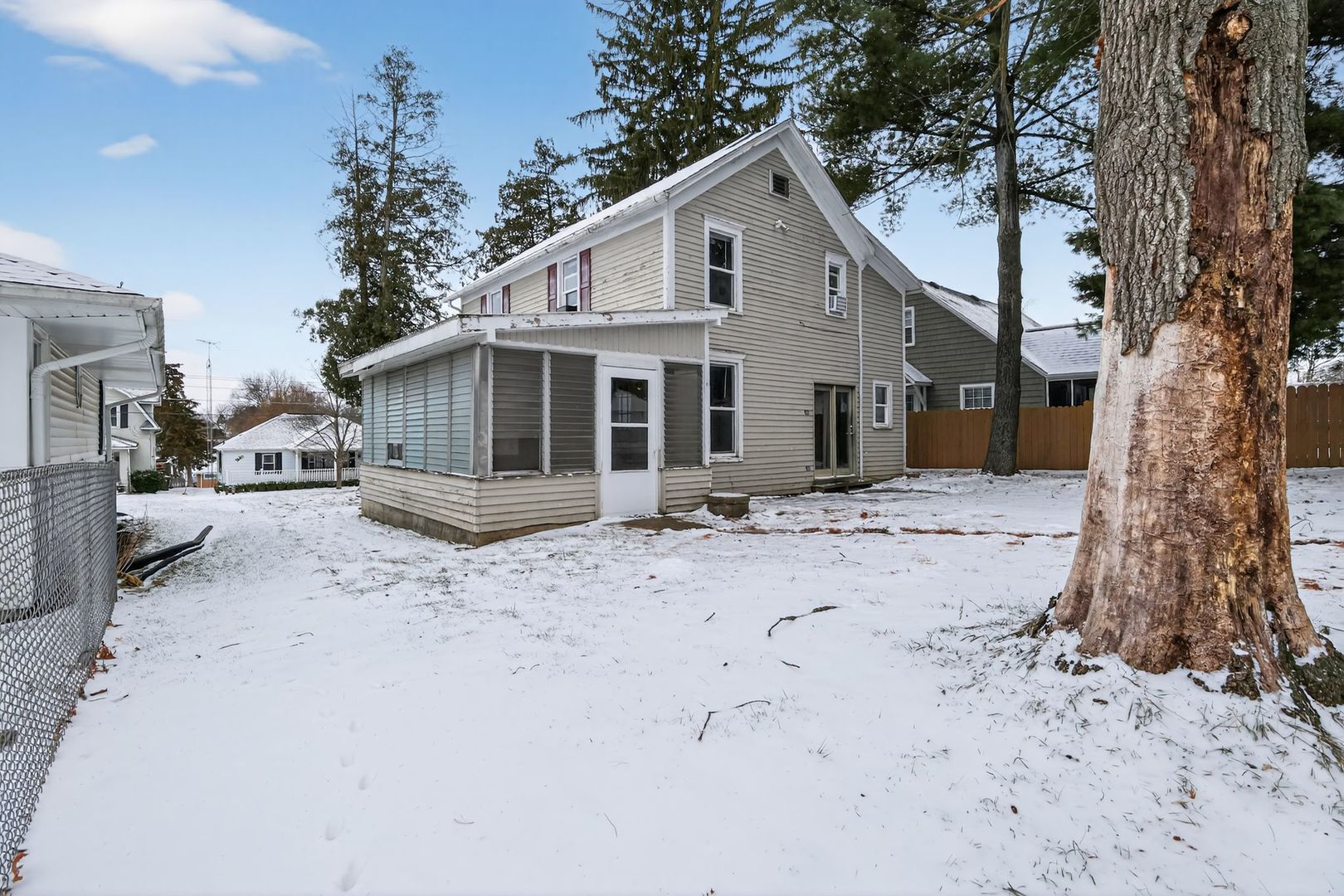 1250 West American Street Freeport, IL 61032 - Photo 21 of 23 a front view of a house with a dirt yard and a large tree