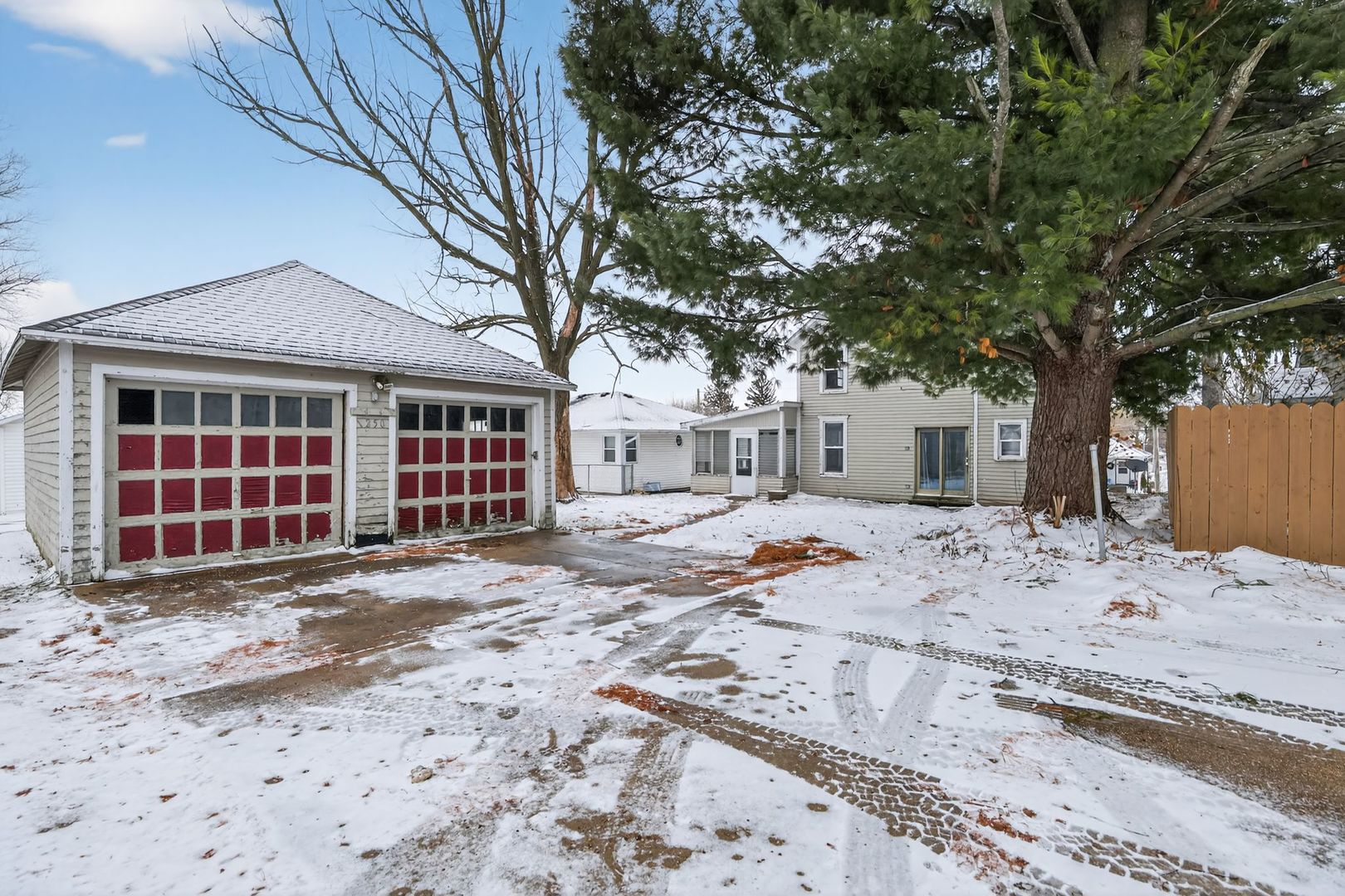 1250 West American Street Freeport, IL 61032 - Photo 23 of 23 a front view of a house with a yard and wooden fence