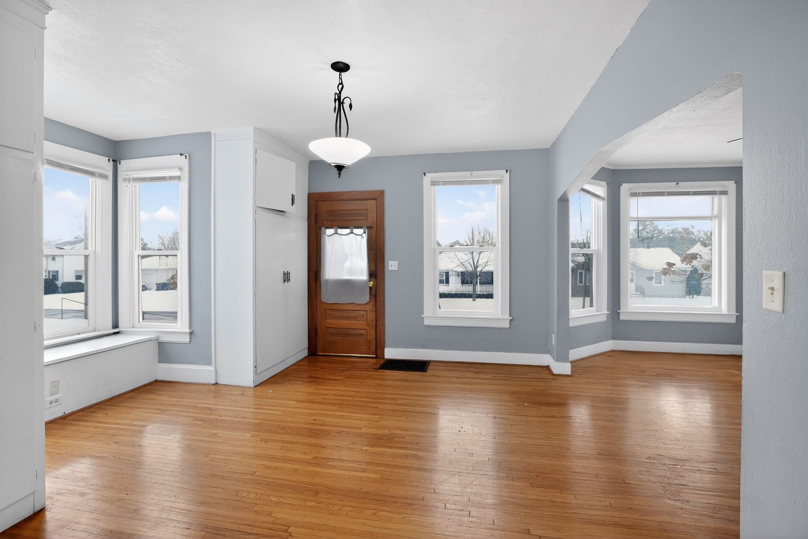 1250 West American Street Freeport, IL 61032 - Photo 3 of 23 a view of an empty room with window and wooden floor