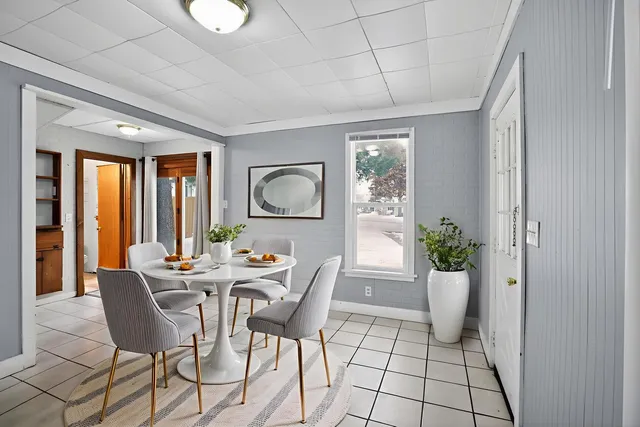 a view of a dining room with furniture window and outside view