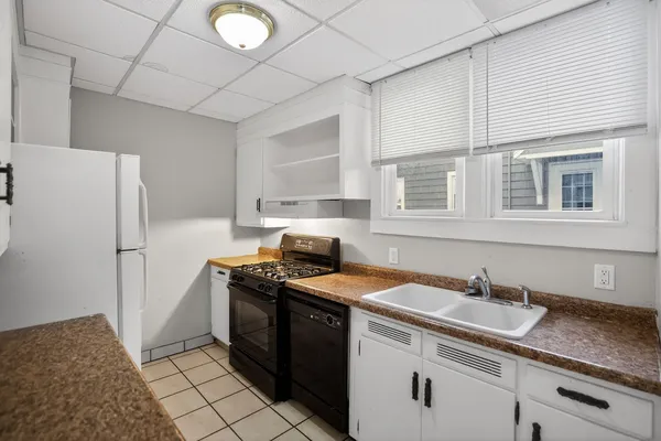 a kitchen with a sink stove and refrigerator