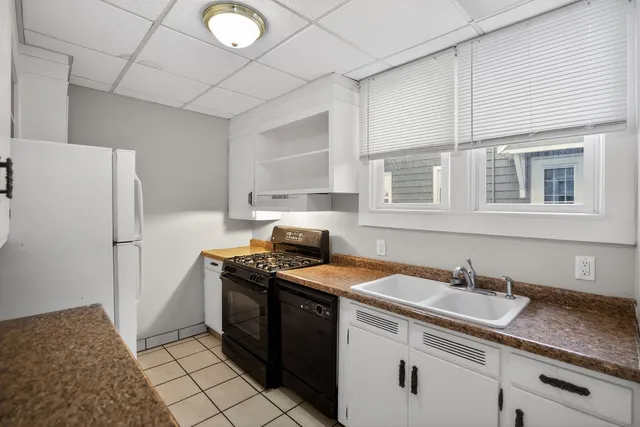 a kitchen with a sink stove and refrigerator