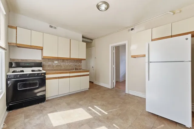 a kitchen with a refrigerator and a stove