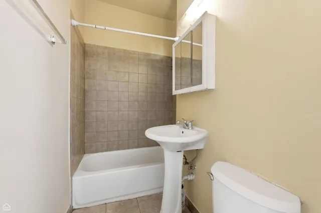 a bathroom with a sink a toilet and bathtub