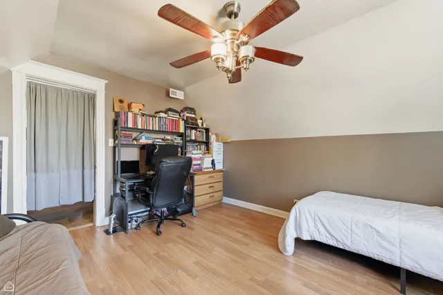 a bedroom with a bed and a chandelier