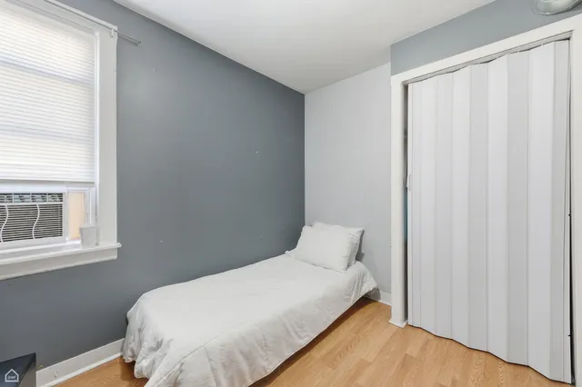 a bedroom with a bed and a window