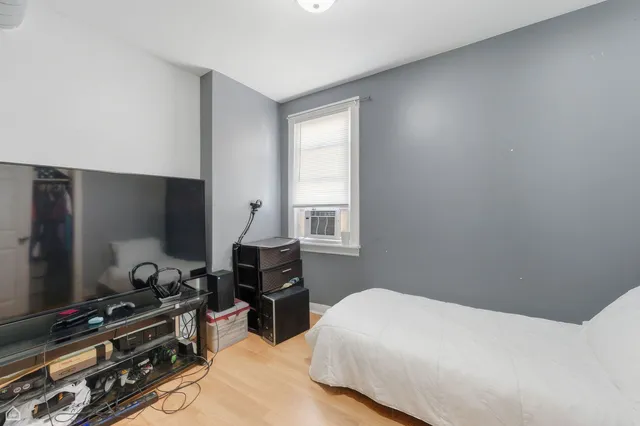 a bedroom with a bed and a flat screen tv