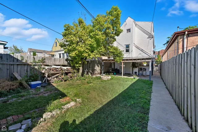a view of a chair and table in the backyard