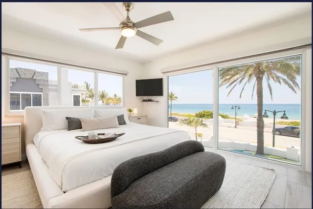 a white table and chairs sitting in front of a house