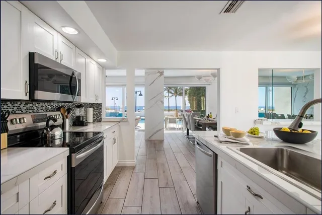 a kitchen with a sink stove and refrigerator