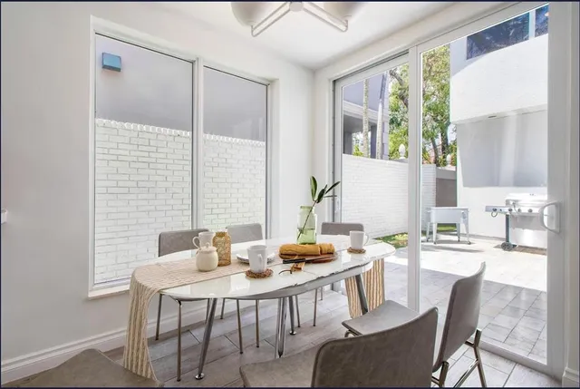 a dining room with furniture a chandelier and wooden floor