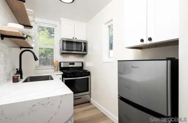 a kitchen with a sink stove and microwave