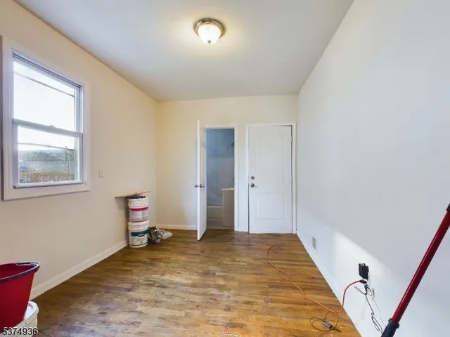 a view of room with window and wooden floor