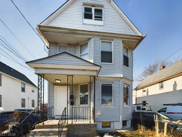 a view of a house with wooden deck