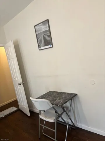 a view of a hallway with furniture and wooden floor