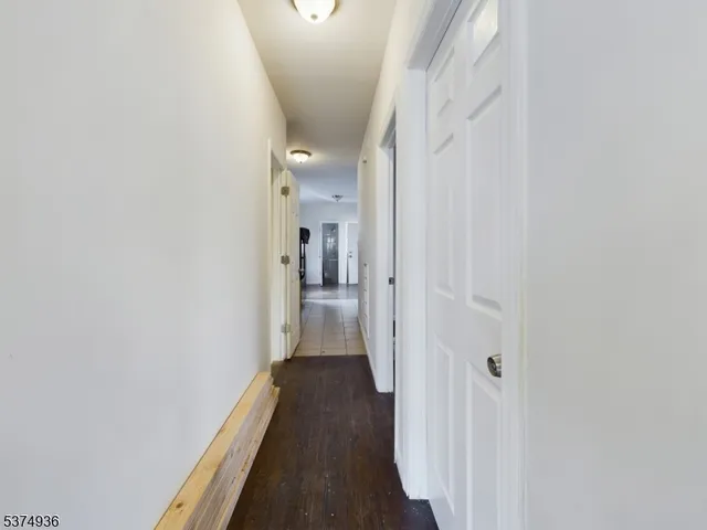 a view of a hallway with a wooden floor