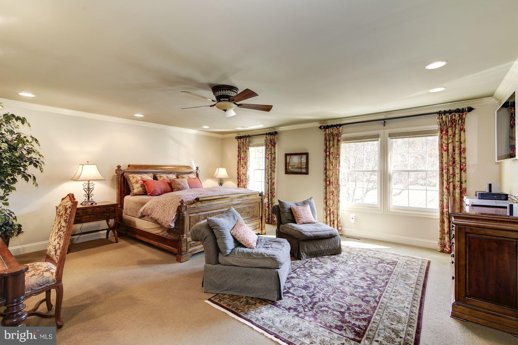 11630 Quail Ridge Court Reston, VA 20194 - Photo 14 of 29 a bedroom with a bed and glass windows