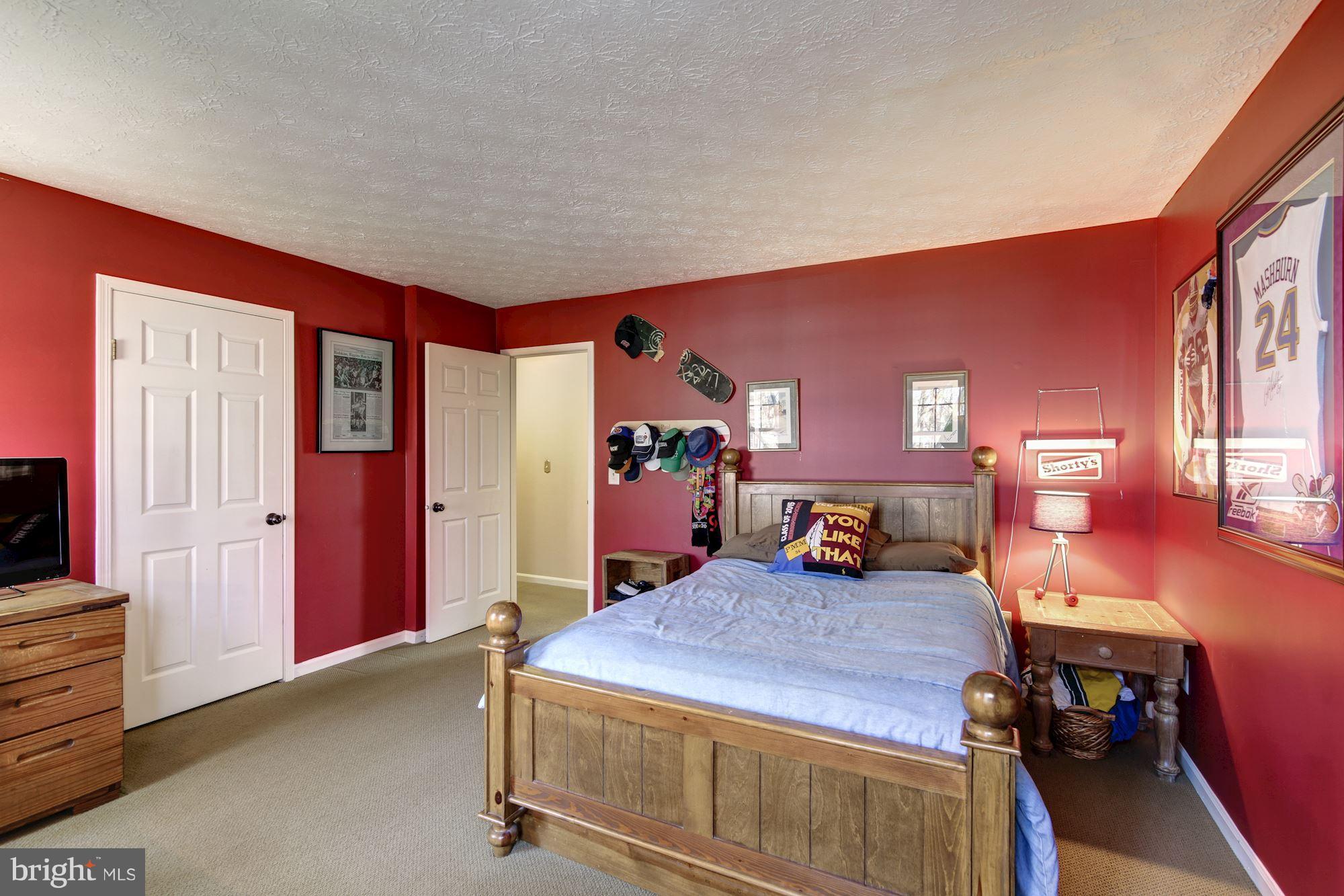 11630 Quail Ridge Court Reston, VA 20194 - Photo 19 of 29 a bed room with furniture and a flat screen tv