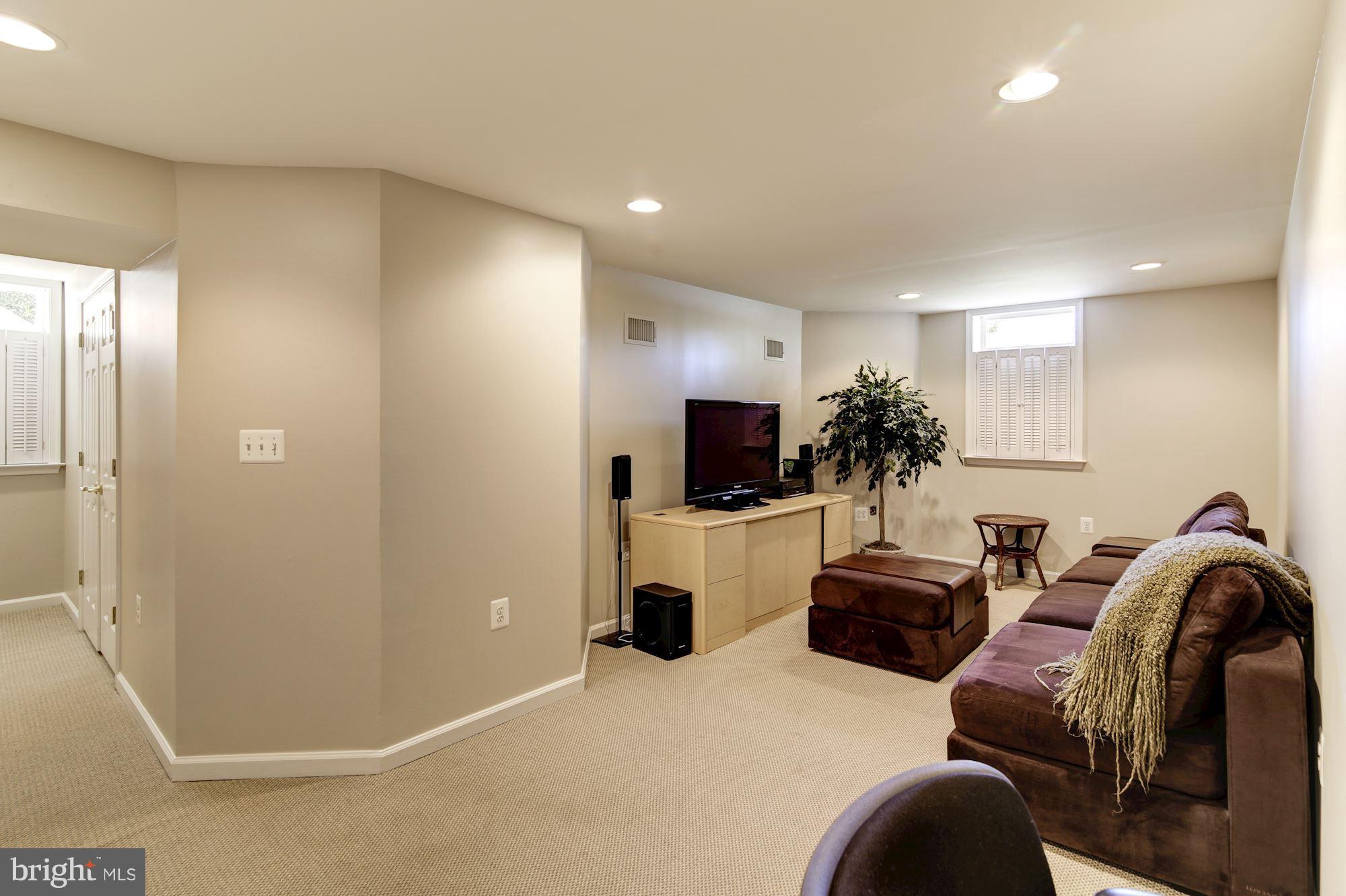 11630 Quail Ridge Court Reston, VA 20194 - Photo 21 of 29 a living room with furniture a flat screen tv and a fireplace