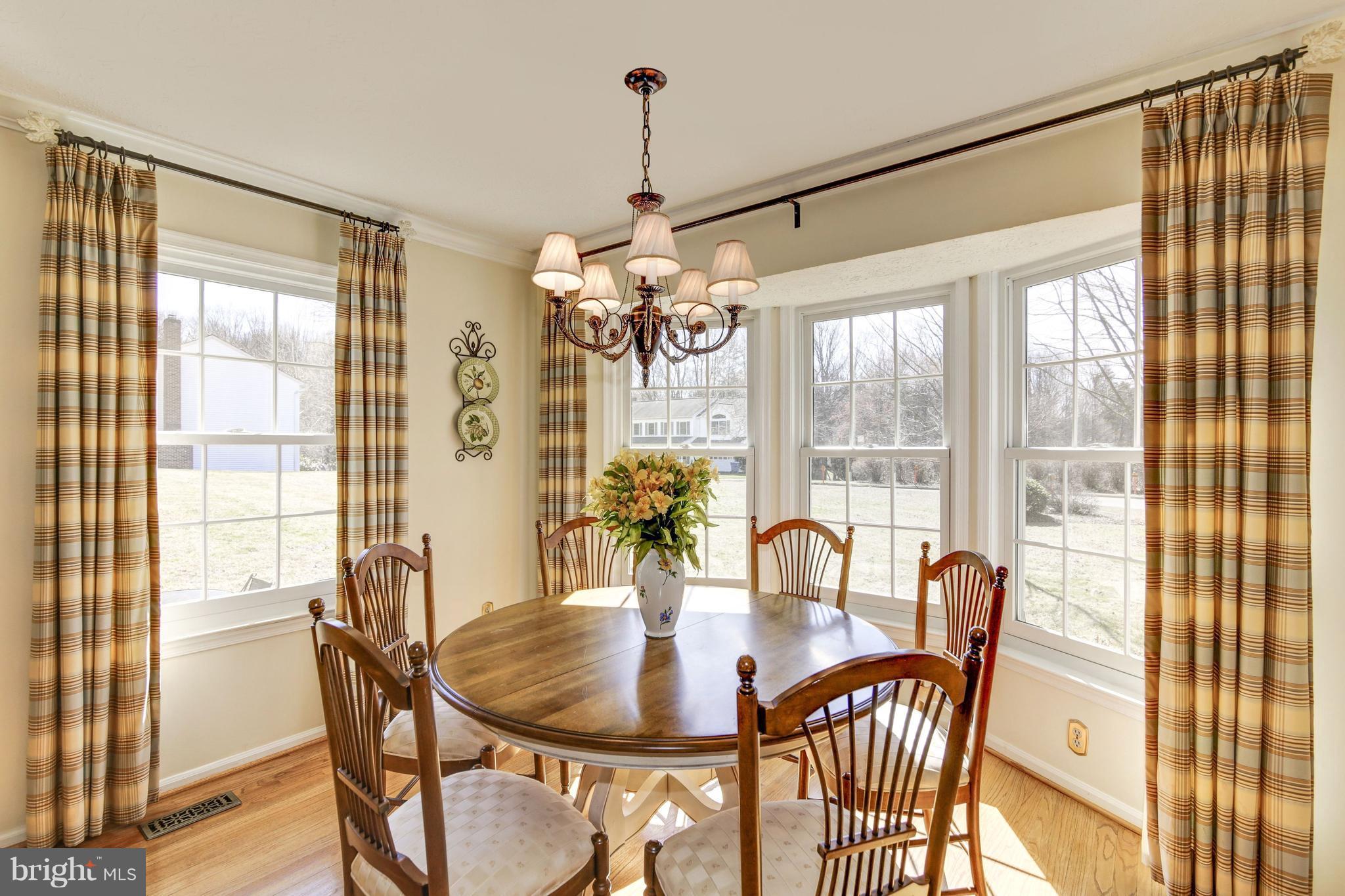 11630 Quail Ridge Court Reston, VA 20194 - Photo 5 of 29 a dining room with furniture a chandelier and wooden floor