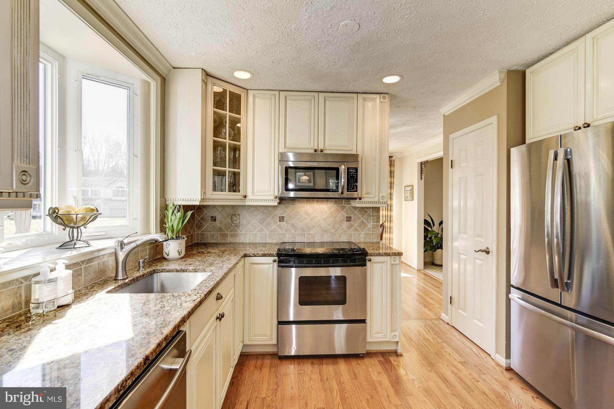 11630 Quail Ridge Court Reston, VA 20194 - Photo 9 of 29 a kitchen with stainless steel appliances granite countertop a refrigerator a stove a sink and a microwave