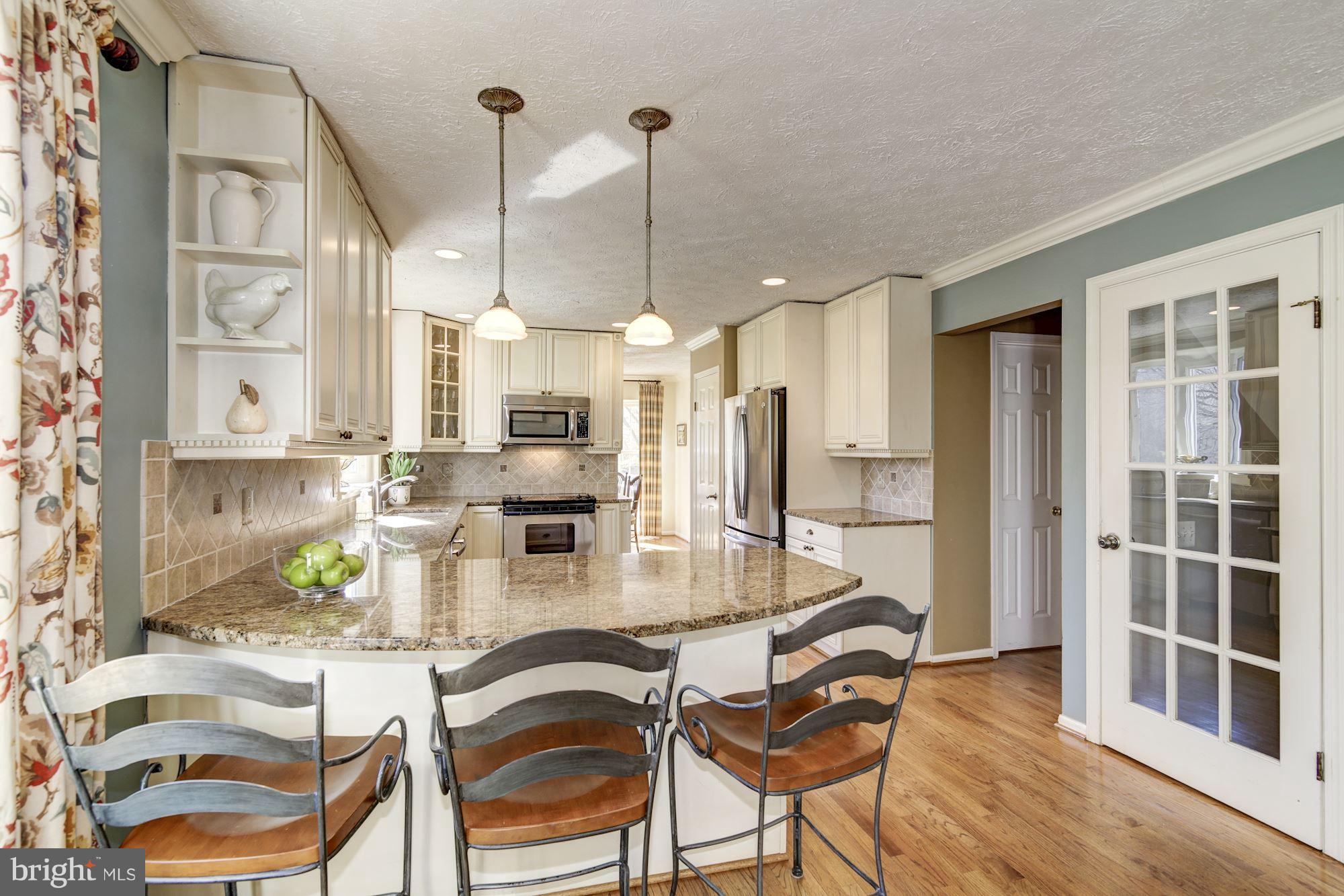 11630 Quail Ridge Court Reston, VA 20194 - Photo 10 of 29 a dining room with furniture a chandelier and wooden floor