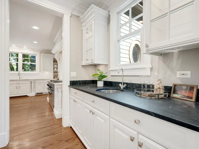 a bathroom with a tub a sink and a mirror
