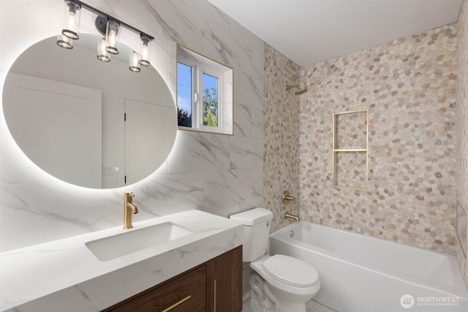 512 Northwest 44th Street Seattle, WA 98107 - Photo 13 of 37 a bathroom with a sink a toilet and bathtub