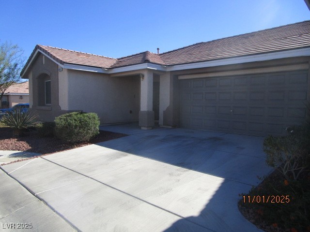 8661 Little Fox Street Las Vegas, NV 89123 - Photo 18 of 18 Single story home featuring concrete driveway, stucco siding, a tiled roof, and a garage
