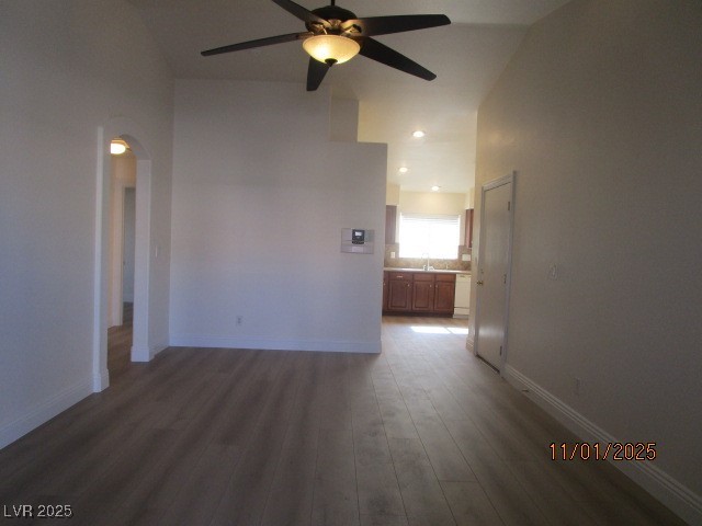 8661 Little Fox Street Las Vegas, NV 89123 - Photo 3 of 18 Empty room with dark wood-type flooring, a ceiling fan, arched walkways, and recessed lighting