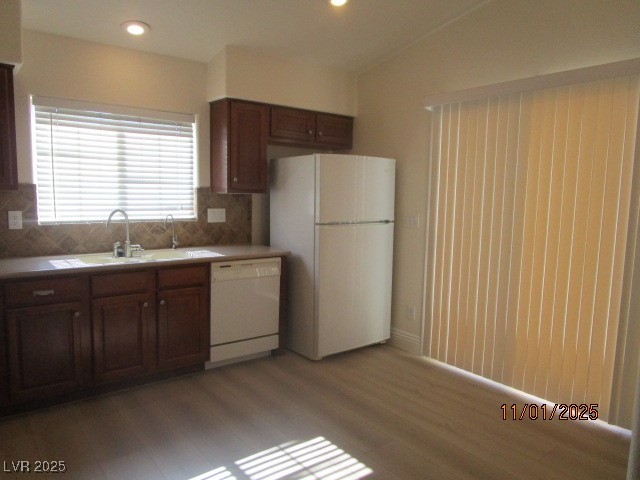 8661 Little Fox Street Las Vegas, NV 89123 - Photo 6 of 18 Kitchen featuring white appliances, backsplash, recessed lighting, light countertops, and dark wood-style floors