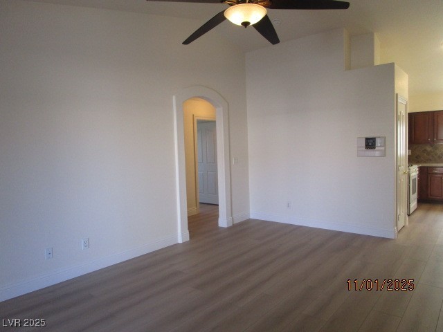 8661 Little Fox Street Las Vegas, NV 89123 - Photo 7 of 18 Spare room featuring wood finished floors, arched walkways, and a ceiling fan