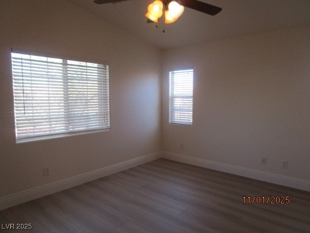 8661 Little Fox Street Las Vegas, NV 89123 - Photo 9 of 18 Empty room featuring dark wood-type flooring, a ceiling fan, and vaulted ceiling