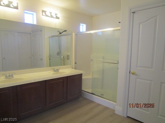 8661 Little Fox Street Las Vegas, NV 89123 - Photo 10 of 18 Bathroom featuring plenty of natural light, double vanity, a closet, and a shower stall
