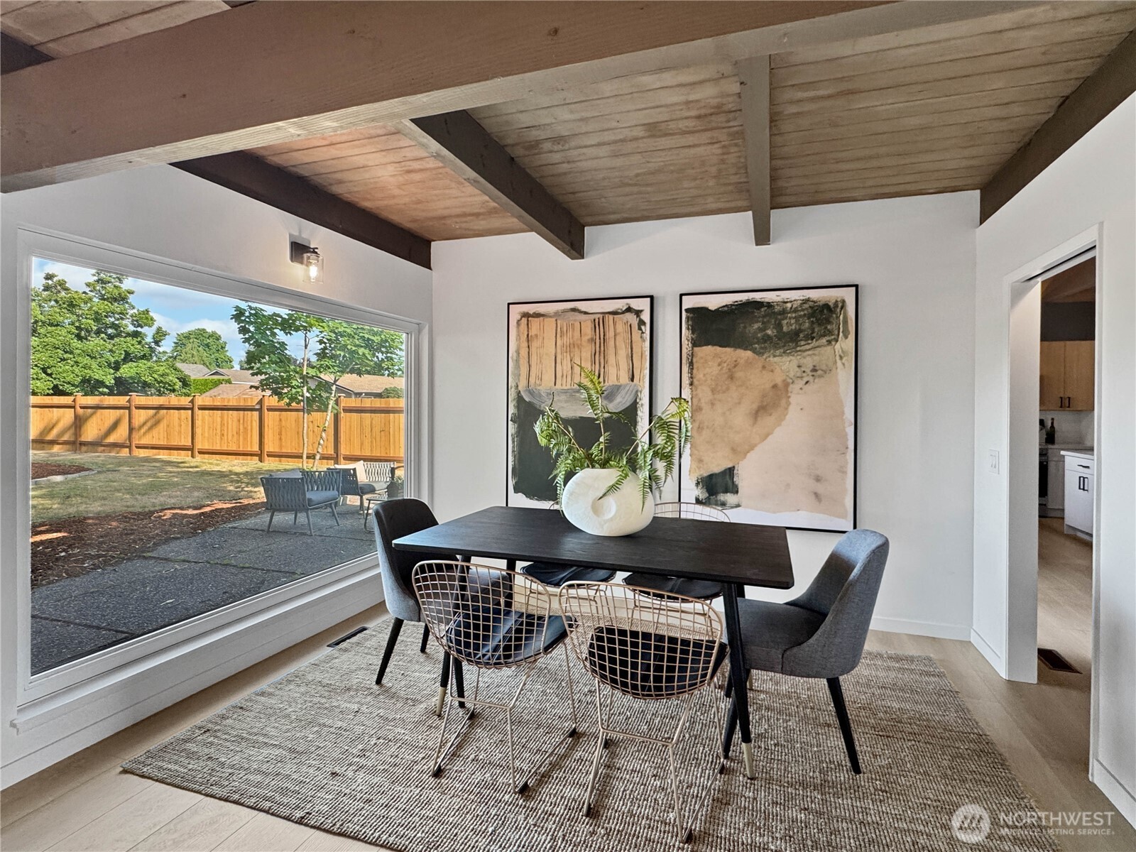 324 Valley Avenue Sumner, WA 98390 - Photo 14 of 34 a dining room with furniture a rug and a floor to ceiling window