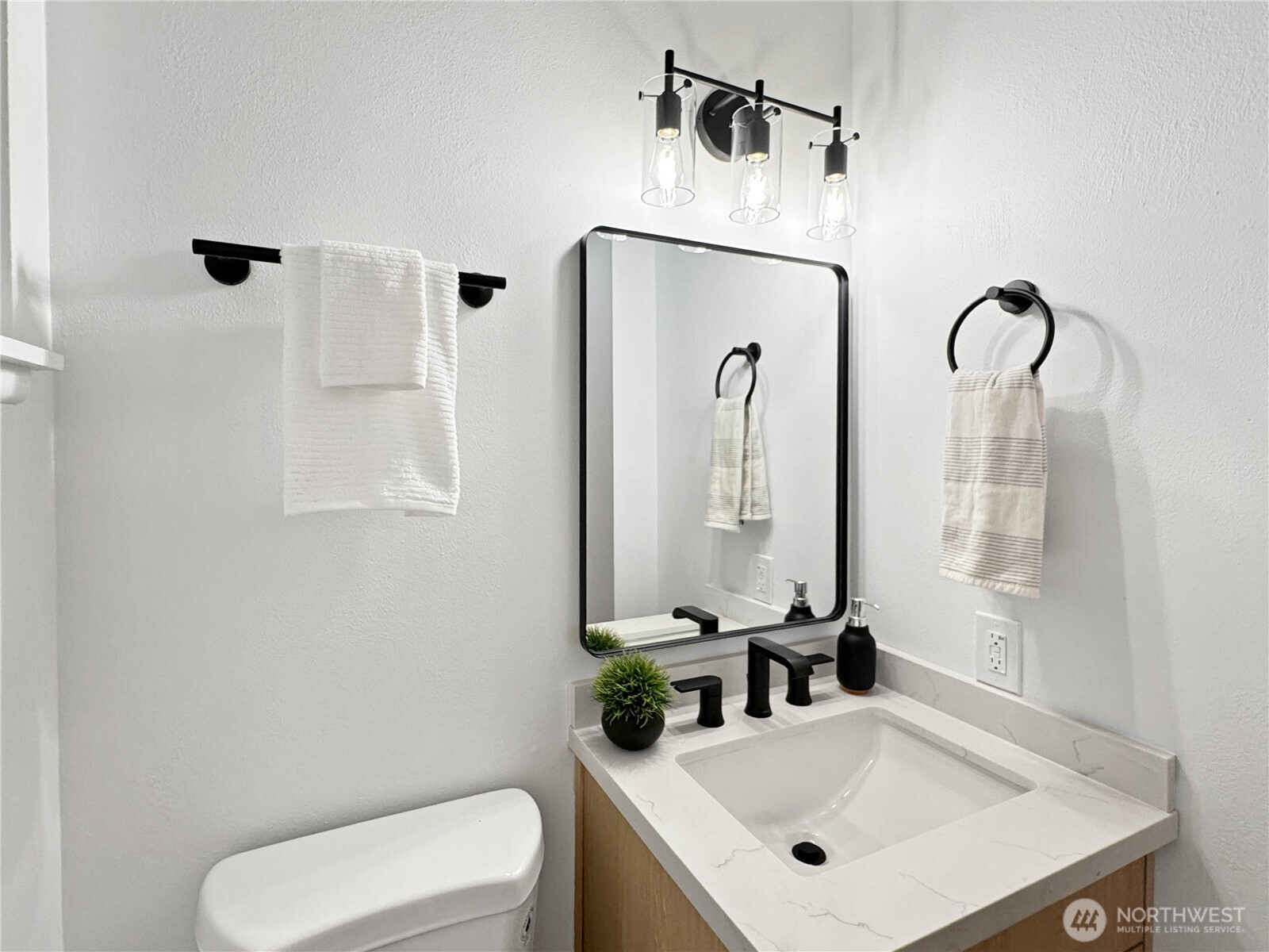 324 Valley Avenue Sumner, WA 98390 - Photo 16 of 34 a bathroom with a sink vanity mirror and toilet