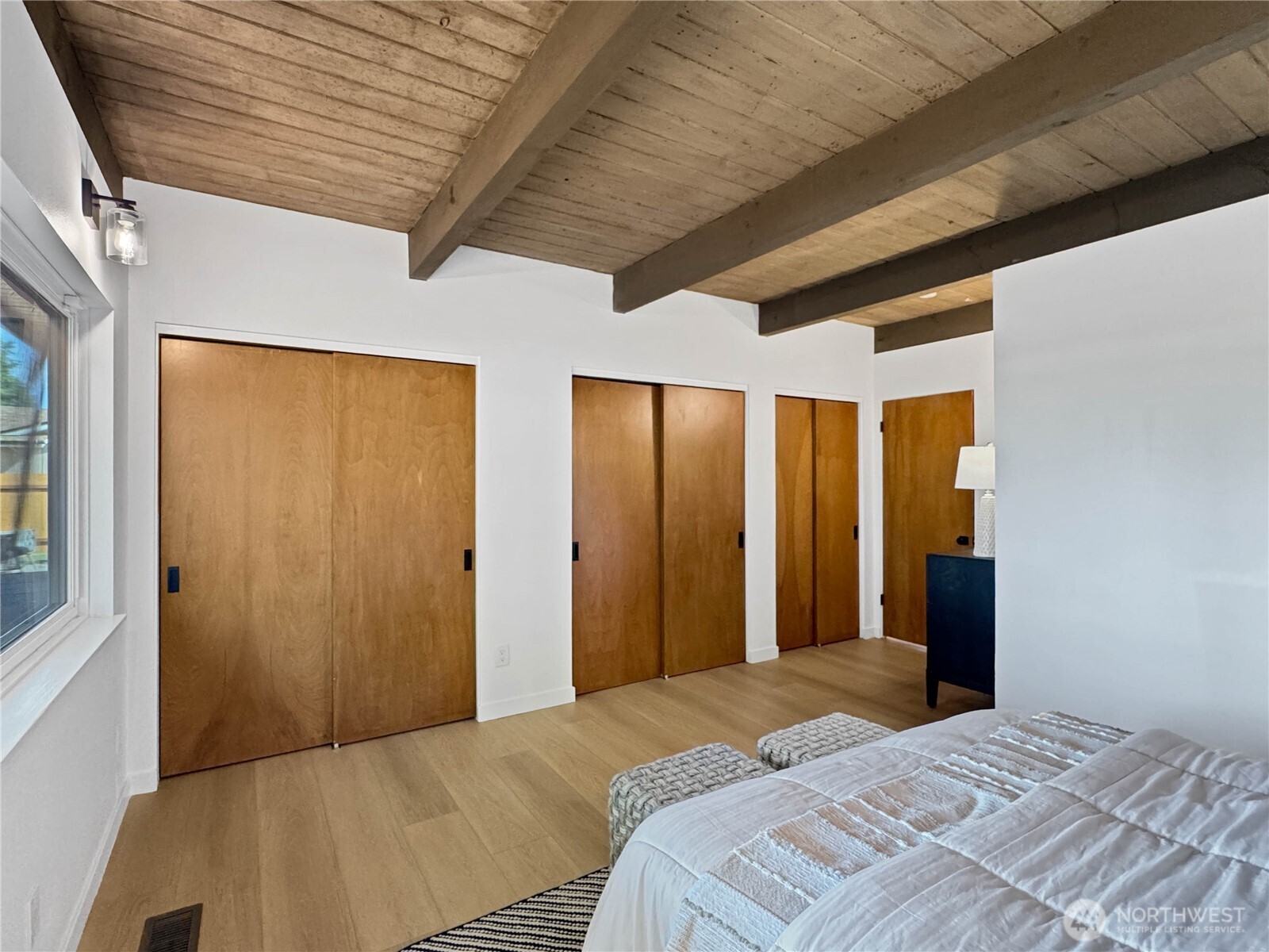 324 Valley Avenue Sumner, WA 98390 - Photo 20 of 34 a bedroom with a large bed and wooden floor