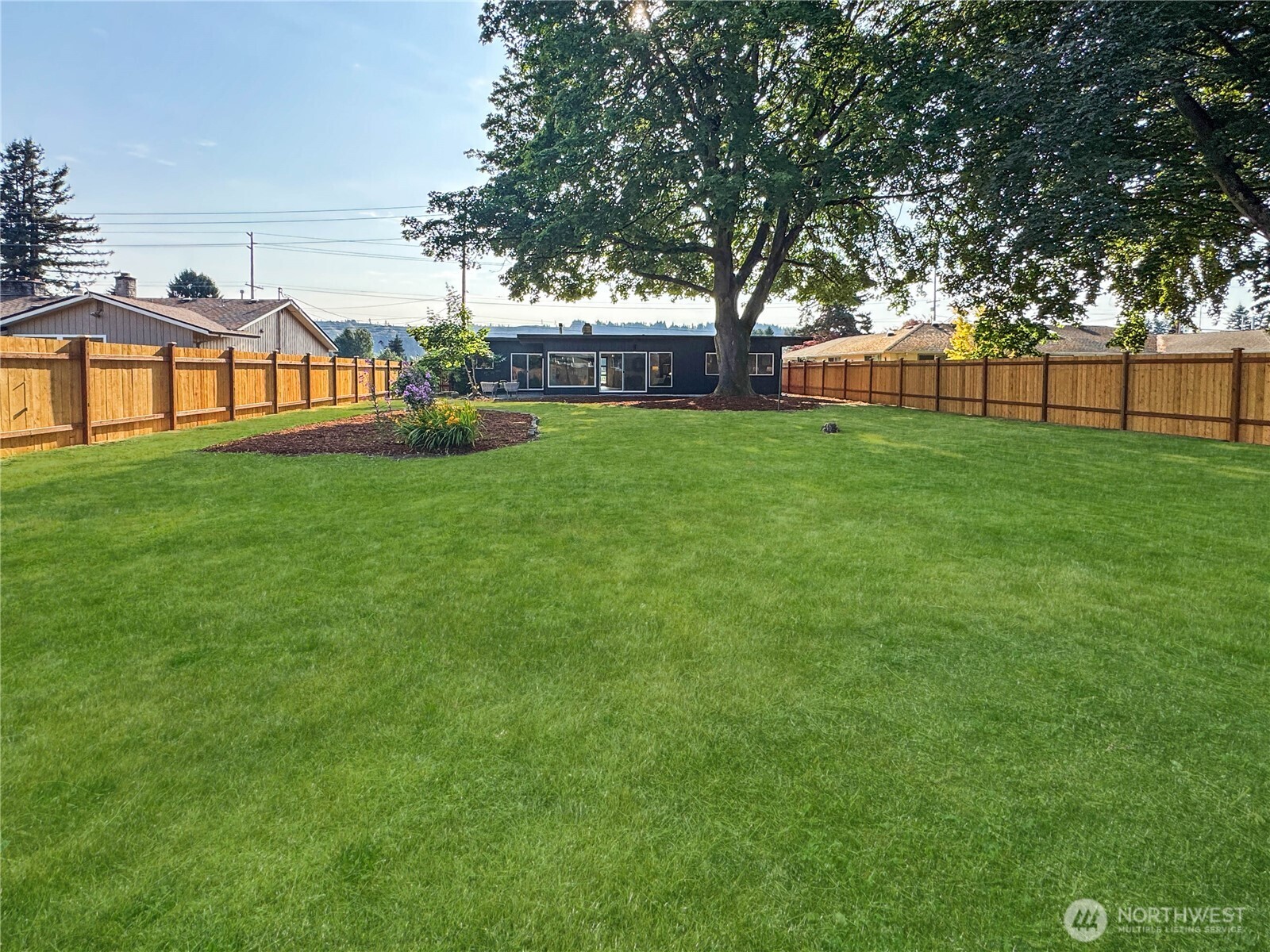 324 Valley Avenue Sumner, WA 98390 - Photo 32 of 34 a view of a yard with a house in the background