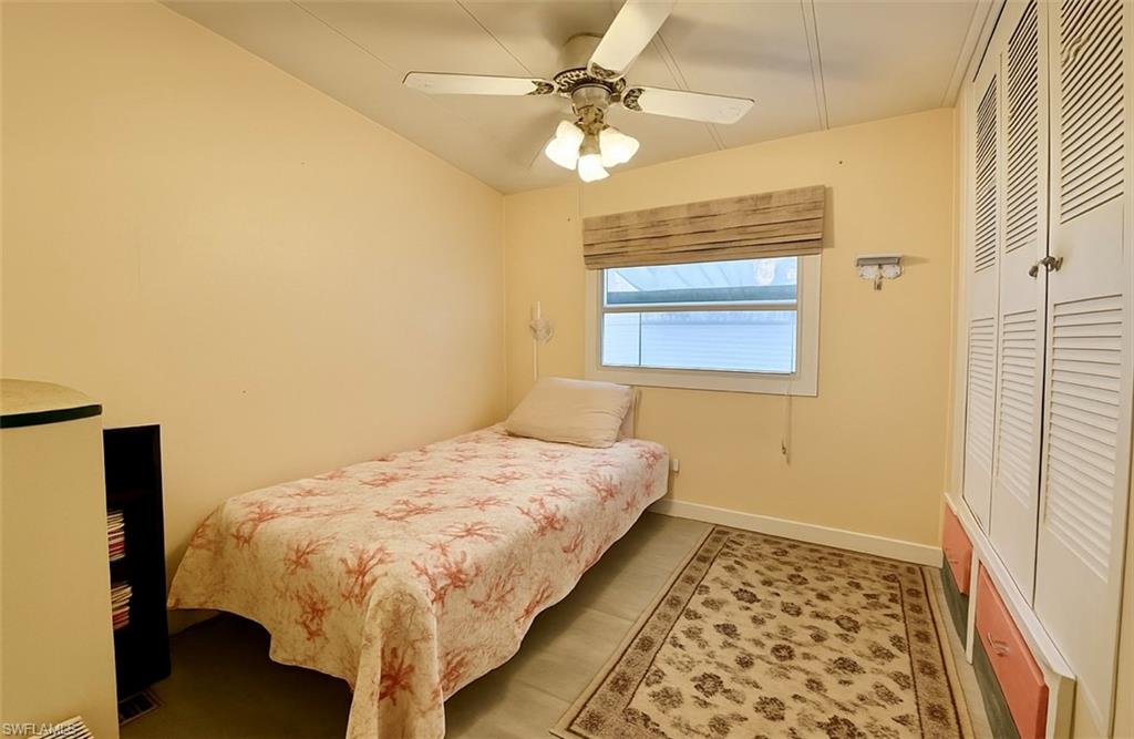 112 Cape Sable Drive Naples, FL 34104 - Photo 13 of 35 a bed sitting in a bedroom next to a window