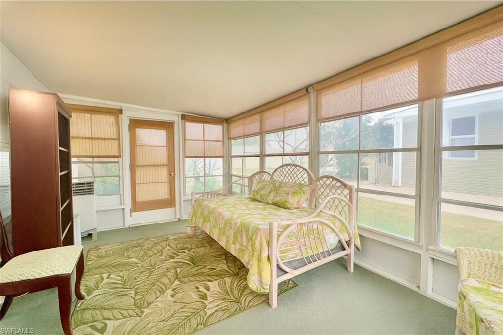 112 Cape Sable Drive Naples, FL 34104 - Photo 17 of 35 a bedroom with a bed and a window