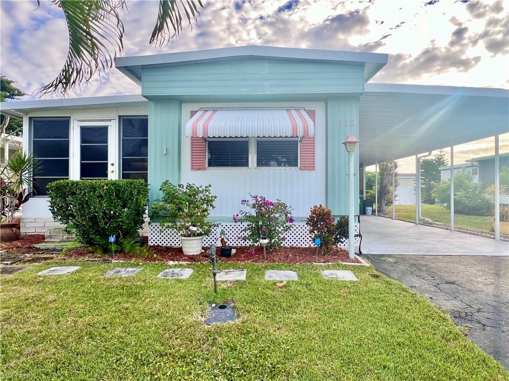 112 Cape Sable Drive Naples, FL 34104 - Photo 24 of 35 a front view of a house with a yard