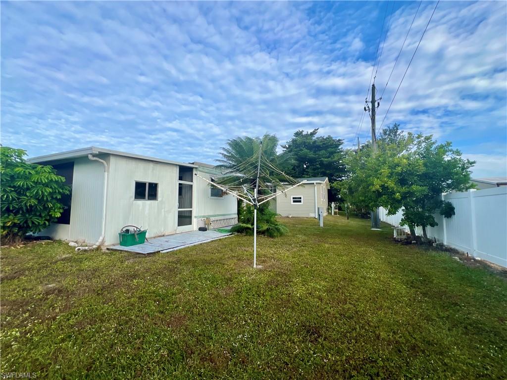 112 Cape Sable Drive Naples, FL 34104 - Photo 27 of 35 a house with a big yard and large trees