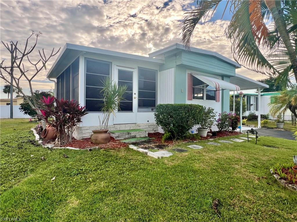 112 Cape Sable Drive Naples, FL 34104 - Photo 29 of 35 a front view of a house with a yard outdoor seating and garage
