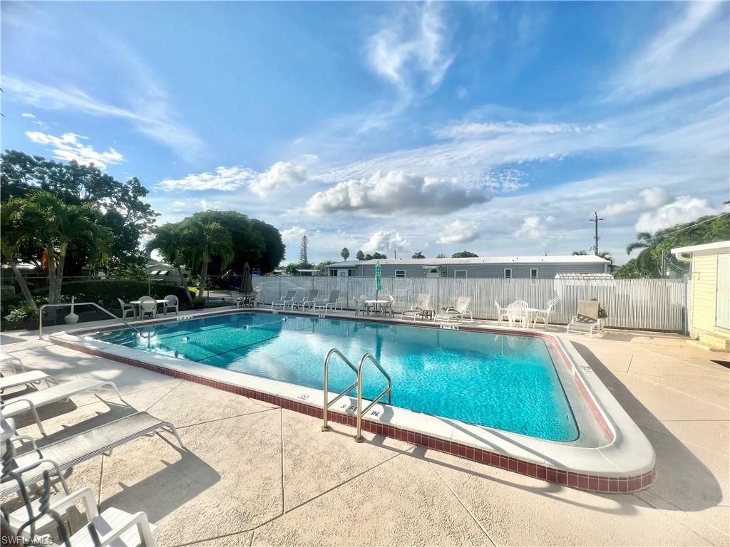 112 Cape Sable Drive Naples, FL 34104 - Photo 31 of 35 a view of a swimming pool with a patio