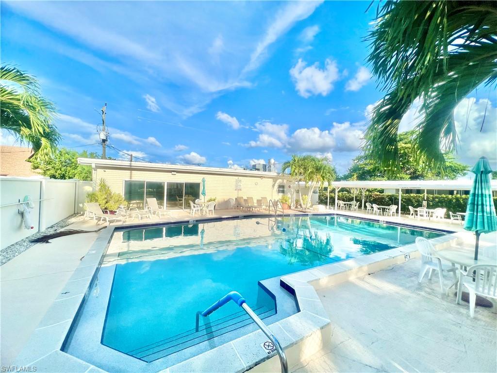 112 Cape Sable Drive Naples, FL 34104 - Photo 33 of 35 a view of a swimming pool with an outdoor seating