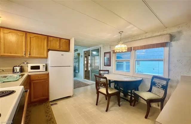 a view of a dining room with furniture and a chandelier