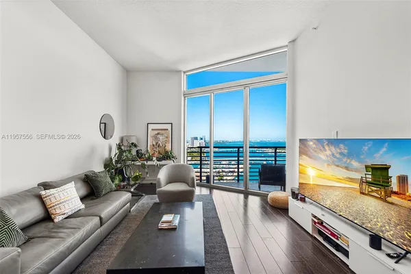 a living room with furniture and a large window