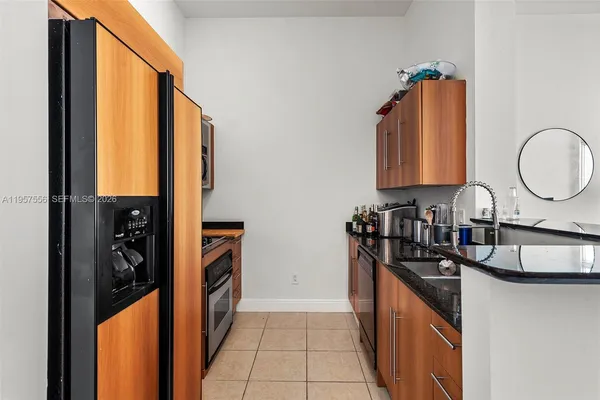 a kitchen with granite countertop a sink and a stove top oven